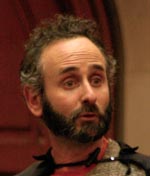 A photo of the messenger’s face. The messenger is a white man with salt-and-pepper hair and a trimmed beard. His mouth is open to speak and his eyebrows are raised.