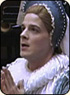 A photo of Julian DeZotti as Cordella. Cordella is a white woman wearing blue and white clothes.